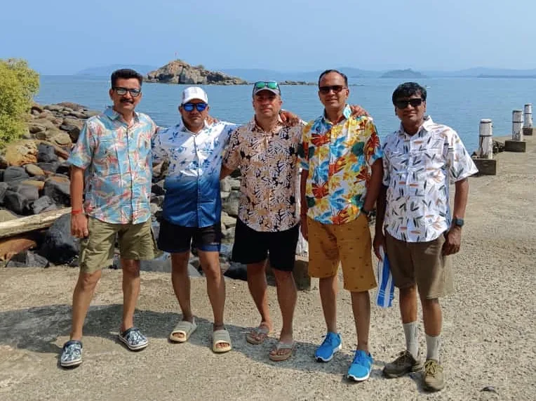 On a pier with my four school friends, ocean behind us.