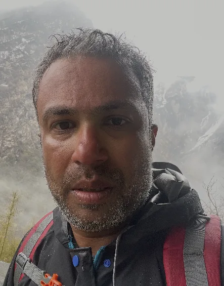 Close portrait, weathered face, beard, mist in the background.
