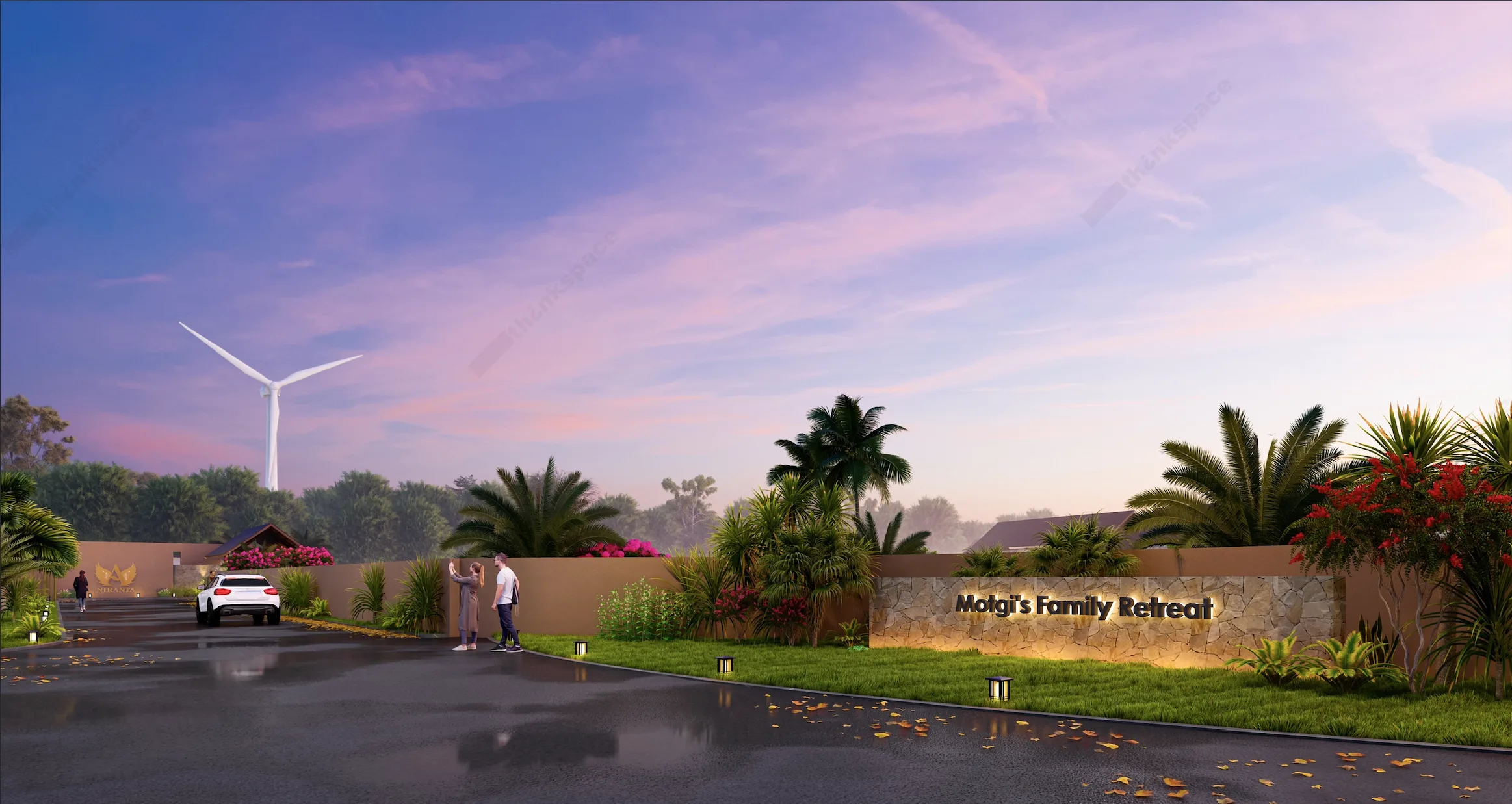 The entrance to Niranta Life with the property name carved in stone, a Niranta crest on the gate, palm trees and a wind turbine in the distance.