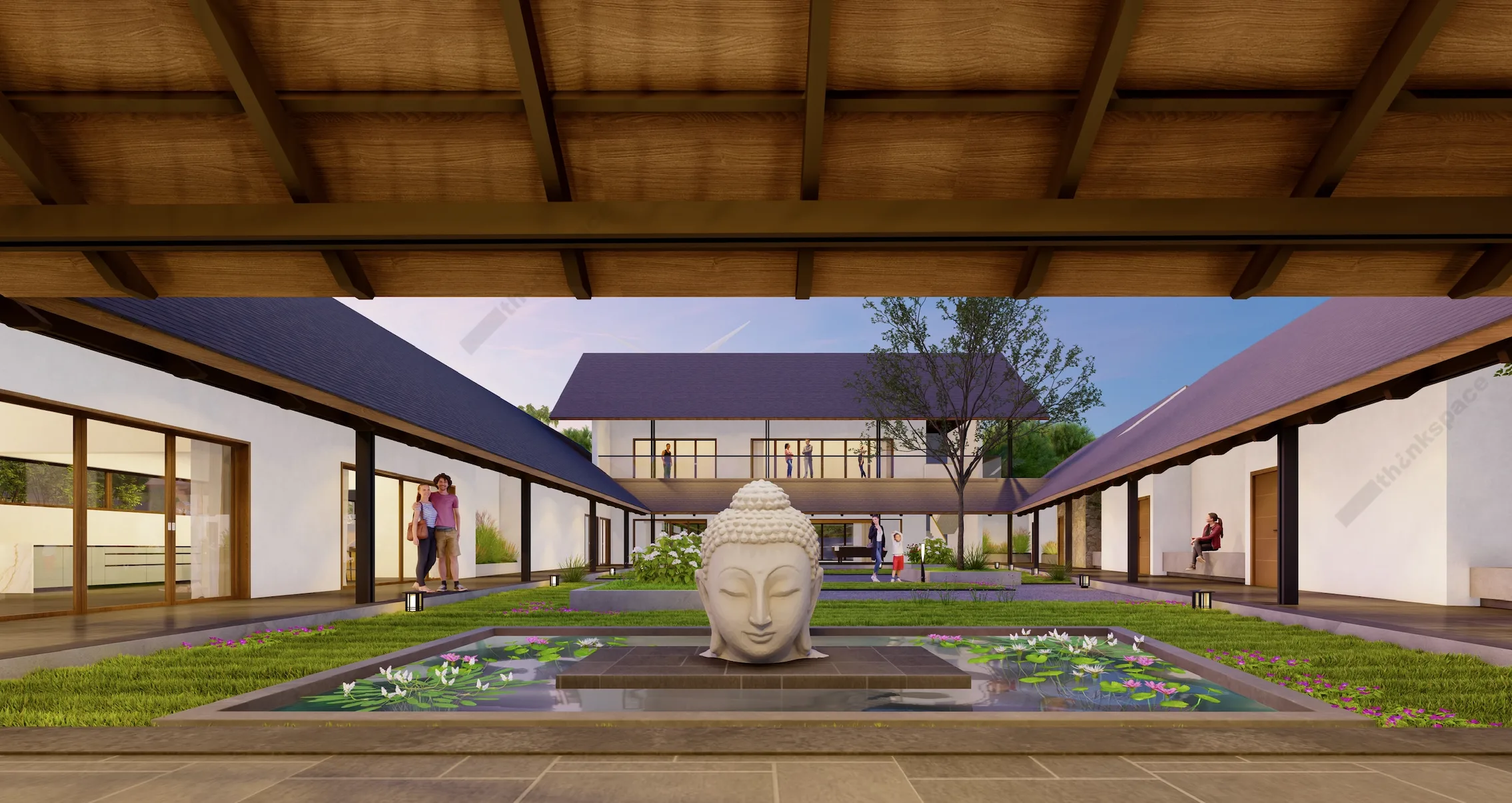 An interior courtyard with a stone Buddha head sculpture, lily ponds on either side, and a long covered walkway connecting the buildings.